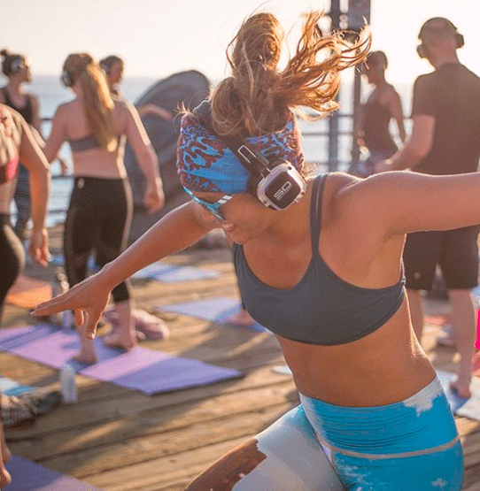 Rooftop yoga with silent disco headphones