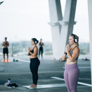 Yoga students wearing Sound Off headphones at an outdoor class