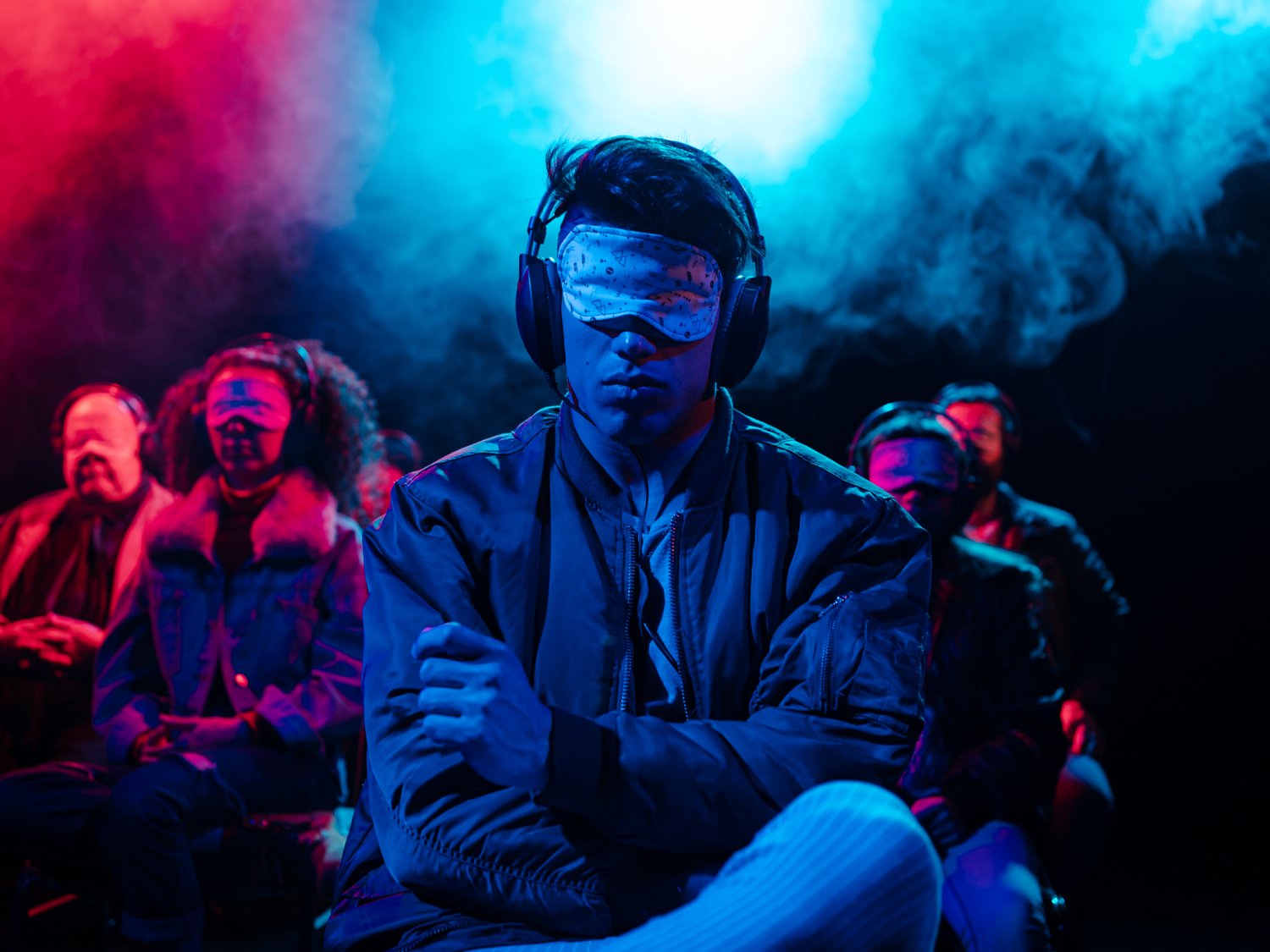 Man wearing silent disco headphones and blindfold at a theater production