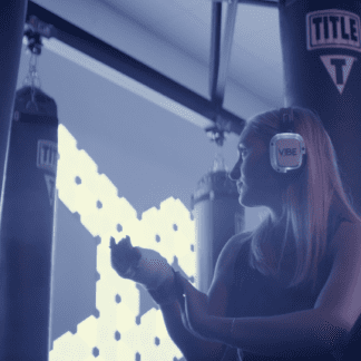 Woman wearing Sound Off headphones at Vibe Boxing Fitness