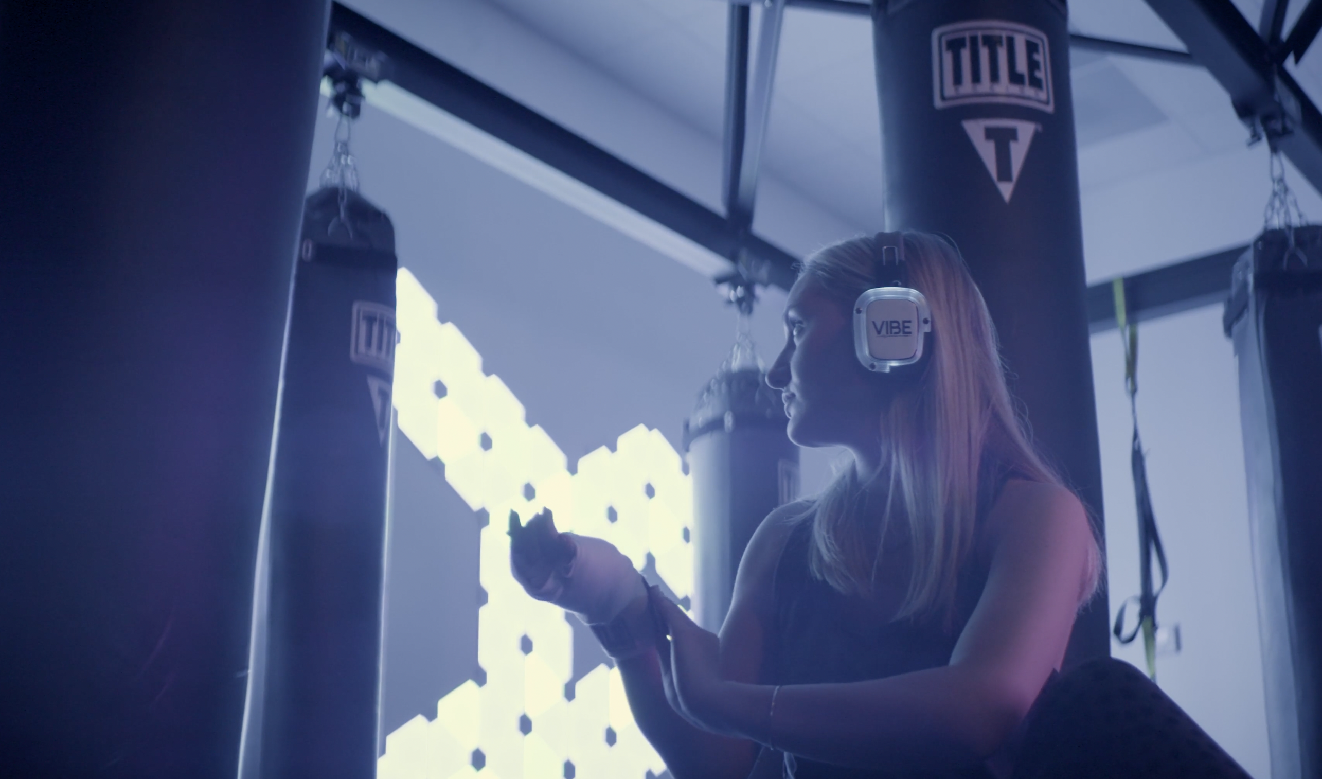 Woman wearing Sound Off headphones at Vibe Boxing Fitness