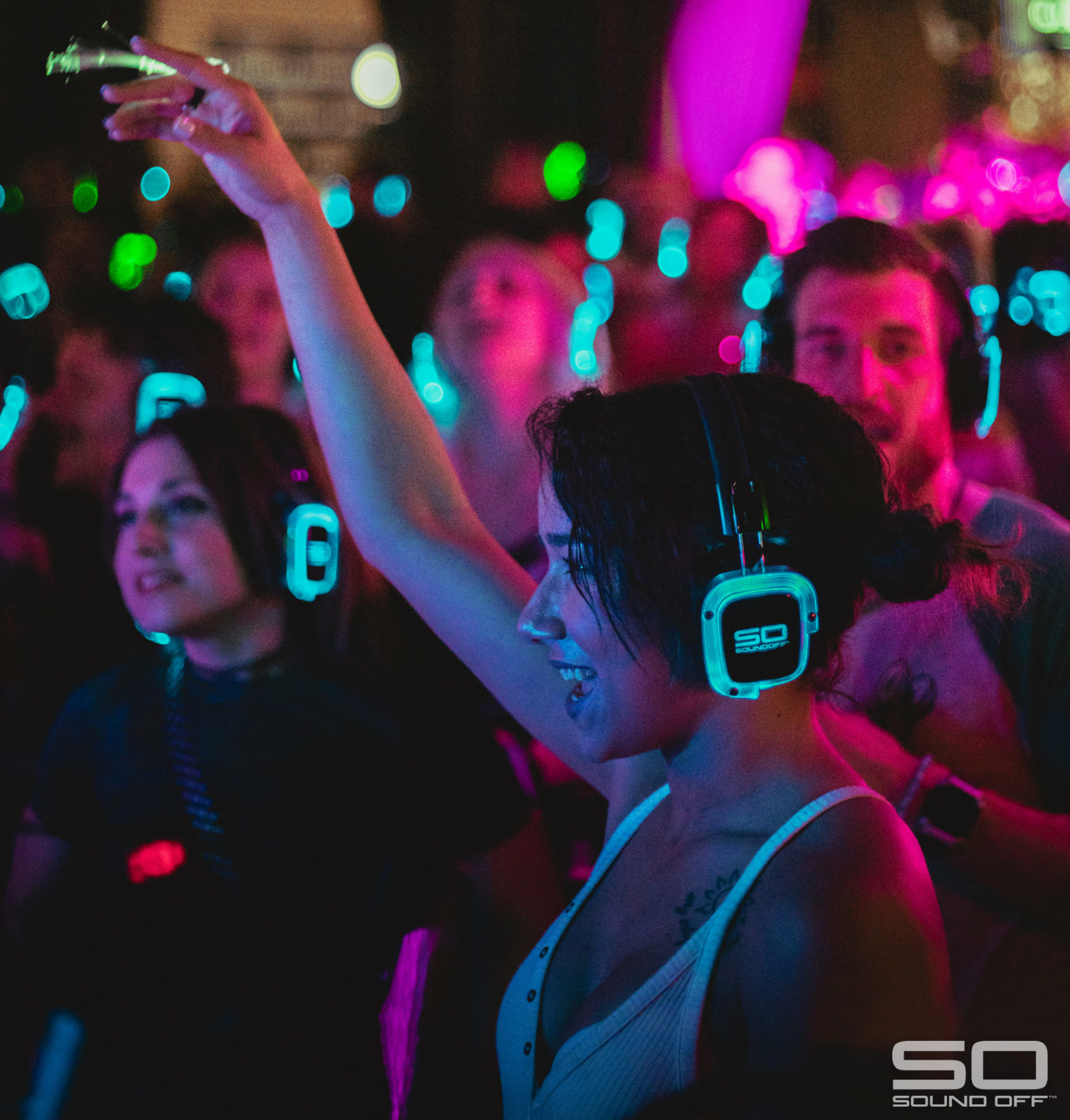Woman wearing Sound Off headphones at a silent disco party