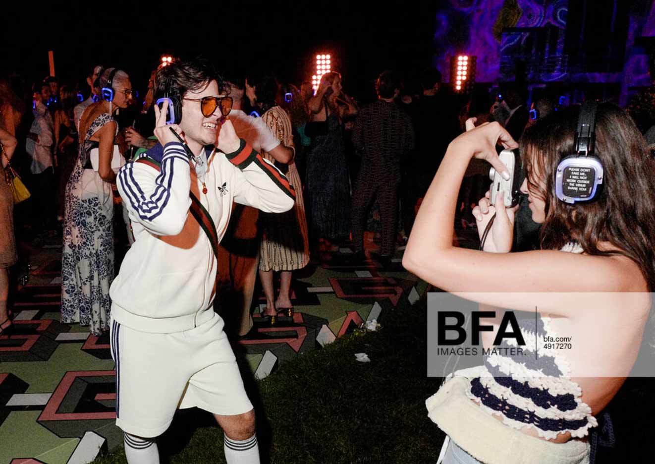 Party goers with silent disco headphones at Gucci party