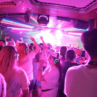 Passengers dancing at a silent disco cruise on the high seas